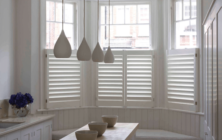 Epping Plantation Shutters Modern and contemporary white-themed kitchen in Annerly installed with Plantation Shutters. Available at Complete Blinds Brisbane.