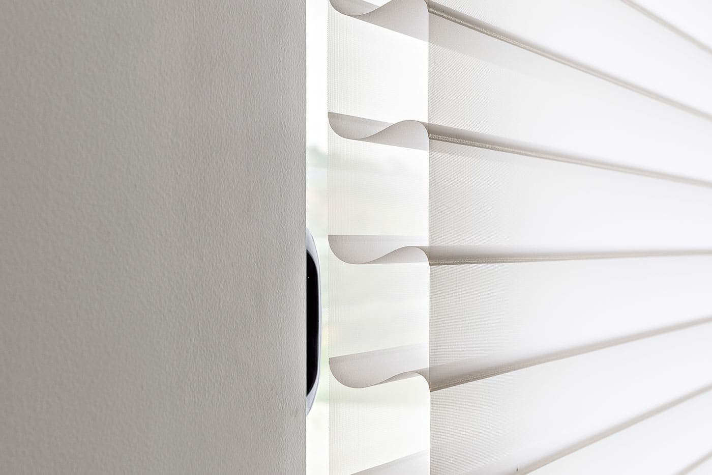 product-benefit-silhouette-shadings-side-profile Close-up image of Silhouette Shades with signature S-Vanes diffusing sunlight and naturally brightening the room. Elegant design with UV protection. Available at Complete Blinds Brisbane.