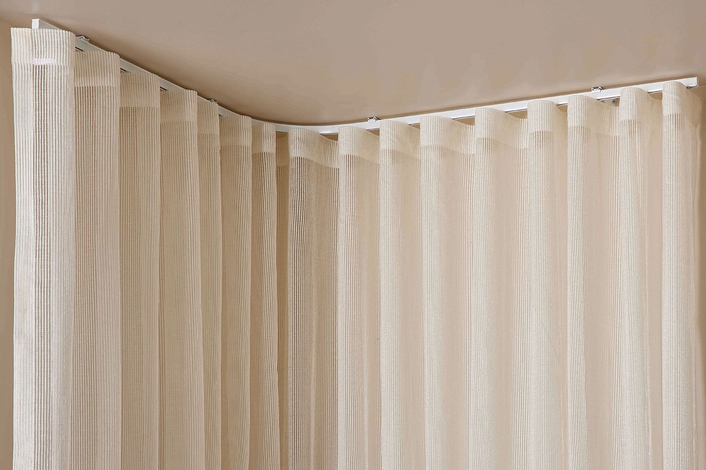 product-benefit-curtains-bent-curtains Beige colour curtains for ultimate privacy and natural light flow control. Available in various fabric designs, systems, and opacity. Available in Complete Blinds Brisbane showroom.