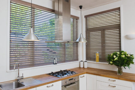 Modern farmhouse style kitchen featuring Timber Venetian Blinds filtering out sun light. On display in our Brisbane showroom.