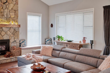 Modern farmhouse styled living space with large sofa and chimney, featuring Timber Venetian Blinds filtering our sunlight. Made in Australia. Available in our Brisbane showroom.