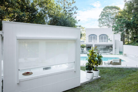 White classical themed home with swimming pool featuring outdoor Evo Awnings installed by Complete Blinds Australia.