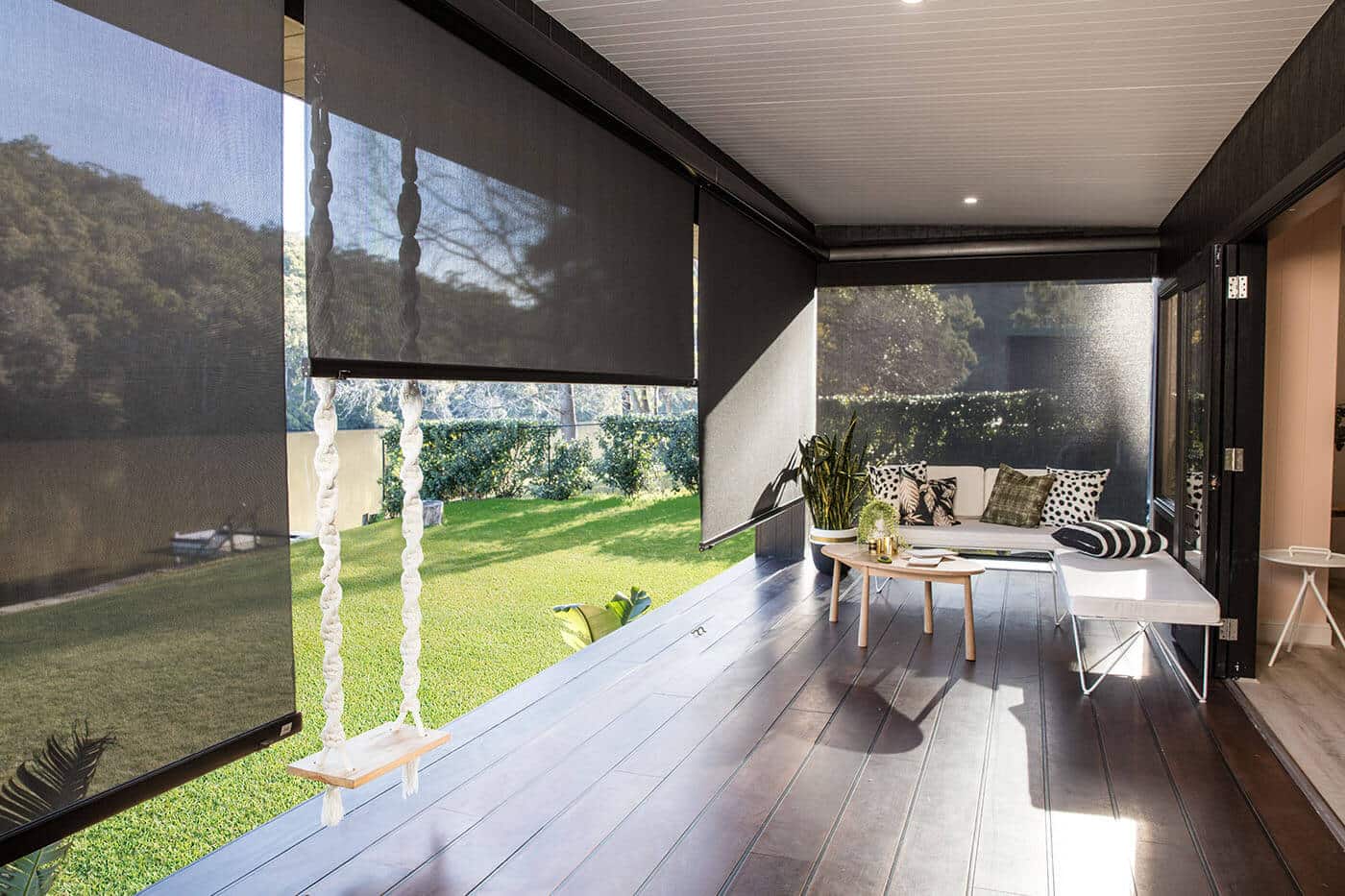 Modern luxurious dark brown themed home patio featuring black outdoor awnings by Complete Blinds Australia.