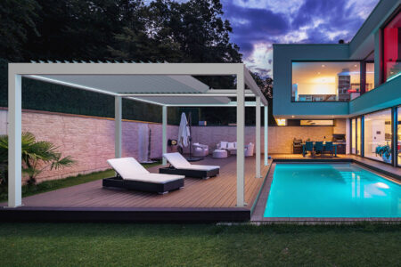 A modern and luxurious home patio with swimming pool featuring Retractable Louvre Roof Pergola Awnings by Complete Blinds Brisbane.