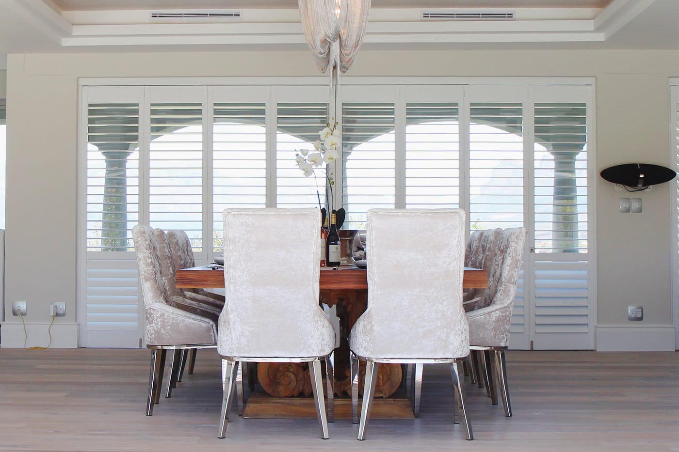 White modern tradition dining area installed with White Shutters by Complete Blinds Brisbane.