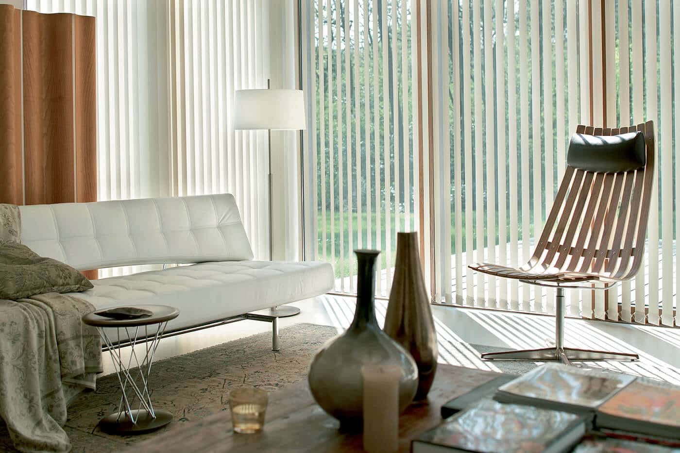 vertical-blinds-benefits-01 A modern, aesthetic and contemporary living room featuring vertical blinds which gently filters sunlight in to the room. Available at Complete Blinds Brisbane.