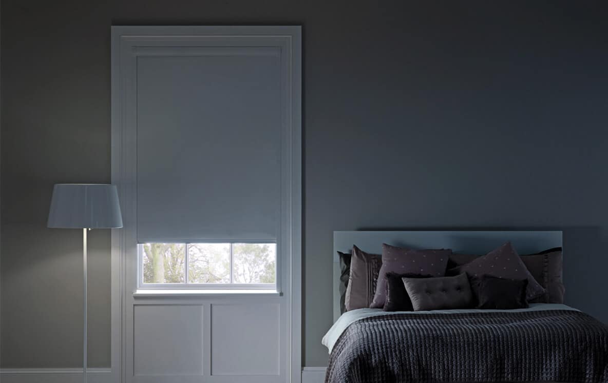 Blinds for Epping Homes Glimpse of sunlight shinning through small gap into bed room. Block-out blinds installed in a cosy bedroom in Indooroopilly. Available at Complete Blinds Brisbane.