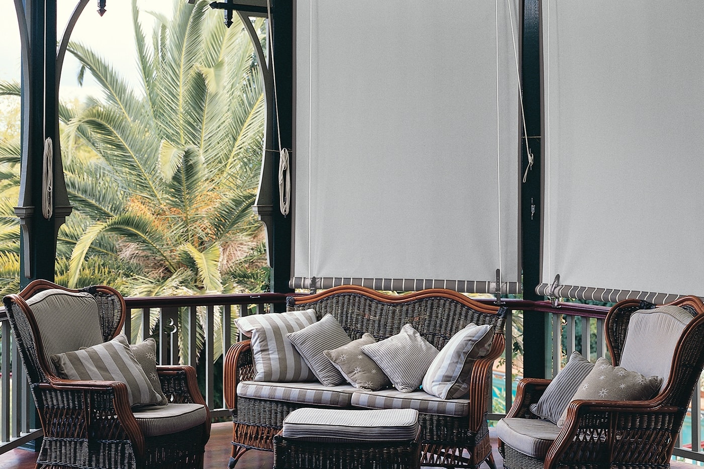 Traditional themed home with wooden outdoor furnitures at patio, featuring outdoor blinds and awnings by Complete Blinds Indooroopilly.