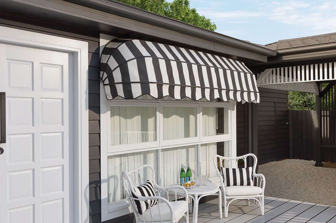 Mid-century themed home with featuring pin-striped outdoor awnings installed at home patio. Outdoor awnings by Complete Blinds Chermside.