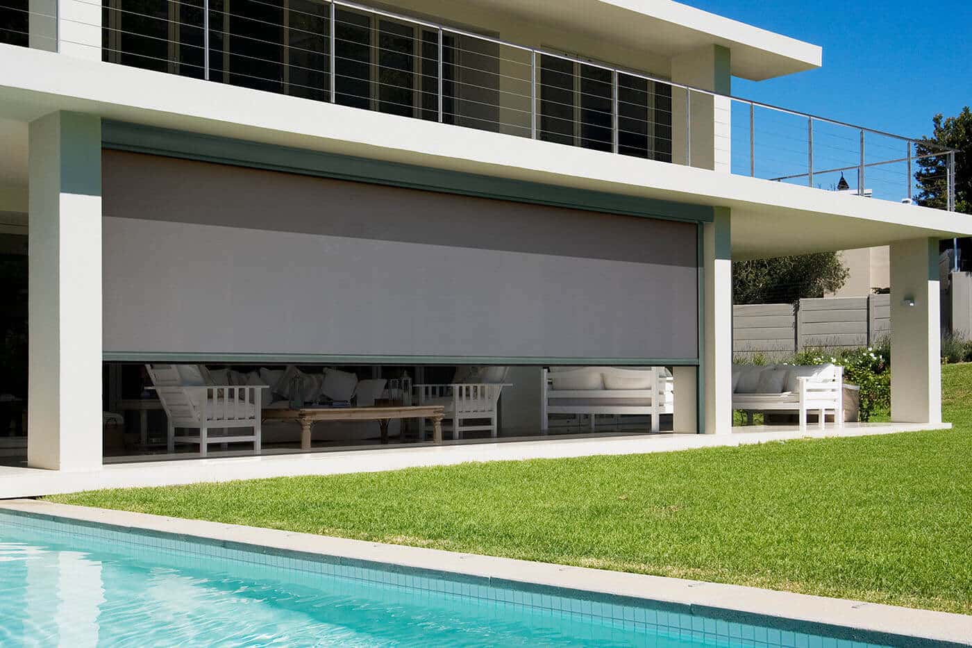 Modern elegant home patio with swimming pool, featuring outdoor awnings by Complete Blinds Indooroopilly.