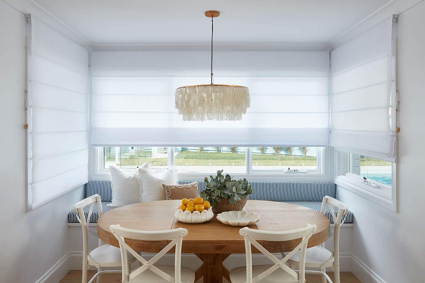 White Roman Blinds installed in a Scandinavian themed dining area in Brisbane.