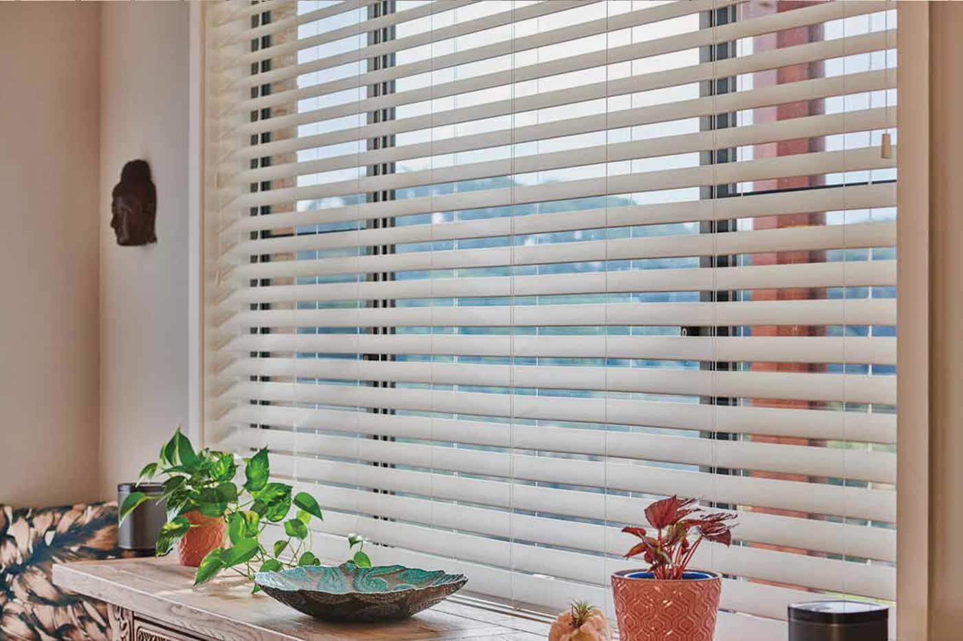 Timber Venetians installed in a living cosy living room in Aspley, allowing for greater light and privacy control. Made in Australia. On display in our Brisbane showroom.