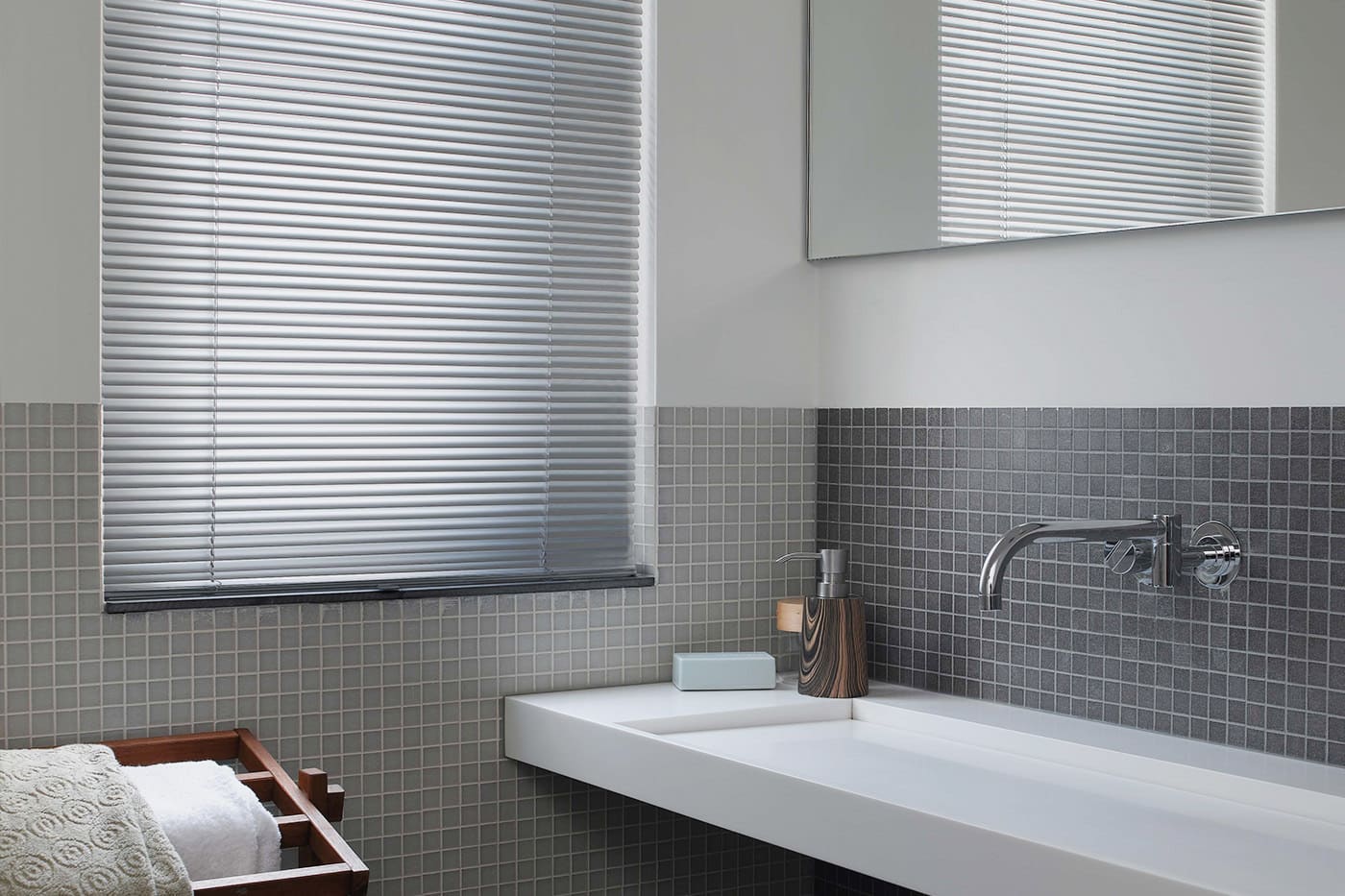 aluminium venetians1 Aluminium venetian blinds, water resistant, installed in a modern and simple grey bath room, window beside the basin. Available at Complete Blinds Brisbane.