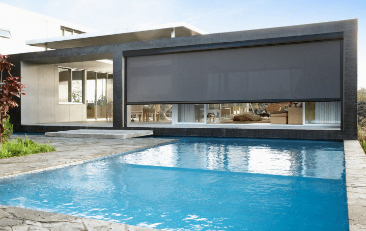 Epping Awnings Modern and luxurious home patio with swimming pool beside, patio installed with outdoor awnings. Available Complete Blinds Indooroopilly.
