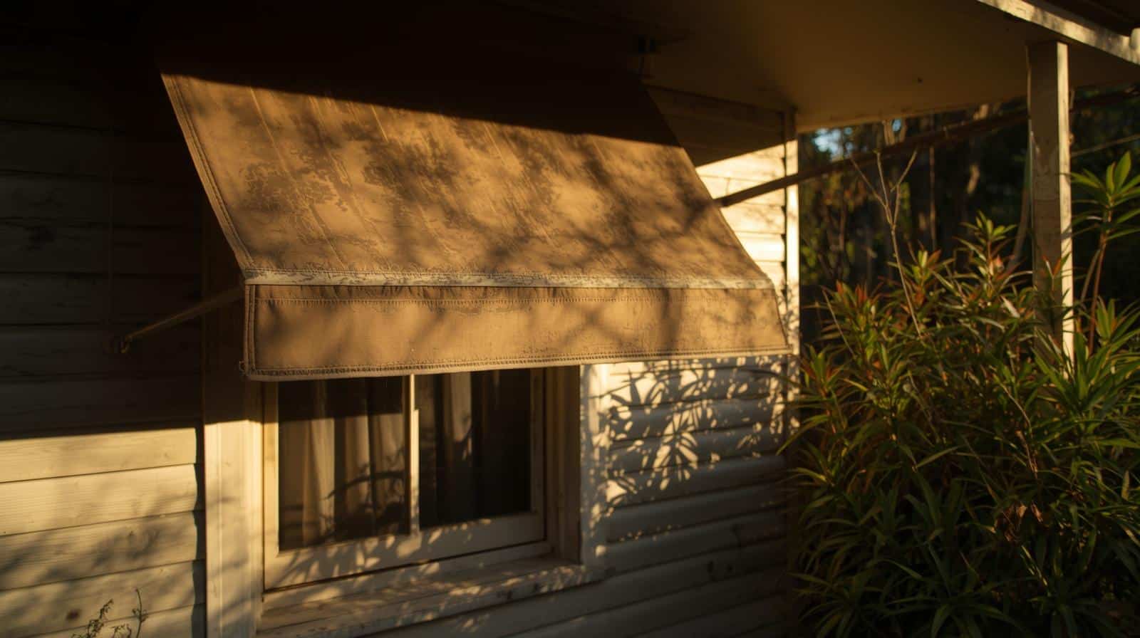 Window awning shading a west-facing window from afternoon sun